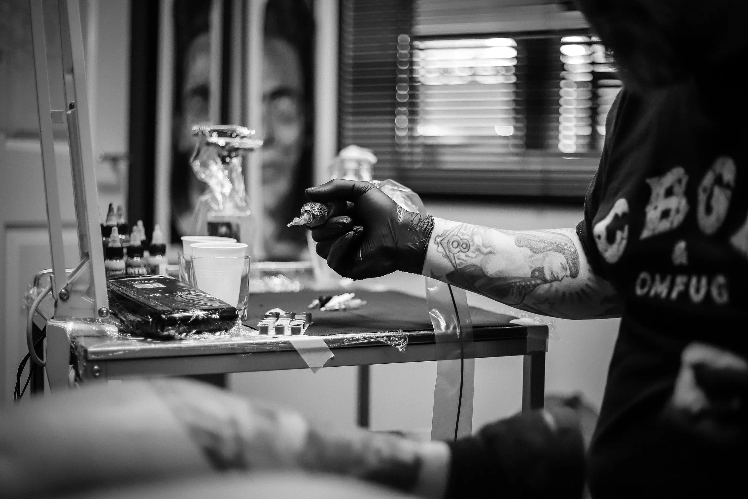 Tattiez artist giving a guest a flash tattoo at a private event